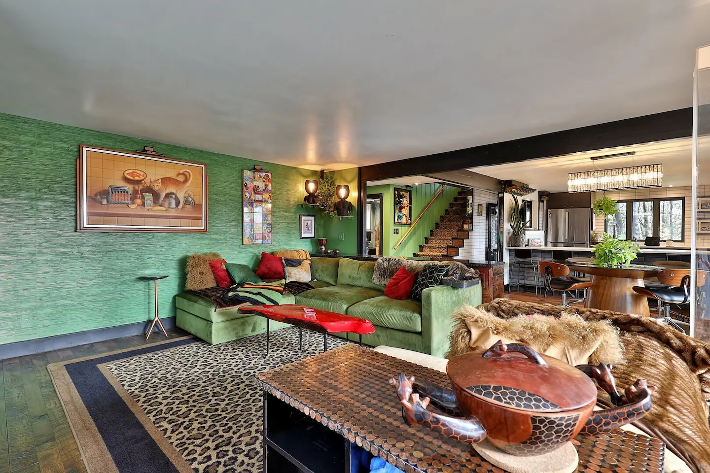 Cozy living room of a Killington, VT ski condo with a sofa, green wall and animal-print furnishings